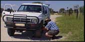 Ben changes a flat tire on the Hilux pickup
